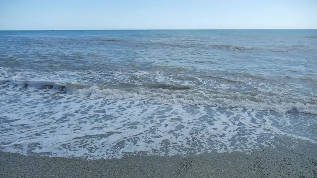 big crashing waves. Sea waves of nature stick and debris in the water rest on the sea travel. Stone beach on sea slow motion video