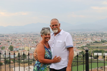 4TH AUGUST, 2017, FETHIYE,TURKEY: A mature couple still in love and on vacation with the town of Fethiye in the background , turkey, 4th august 2017