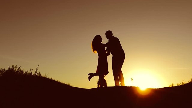 Man and woman silhouettes at sunset.bird couple and dog pet silhouette sunrise