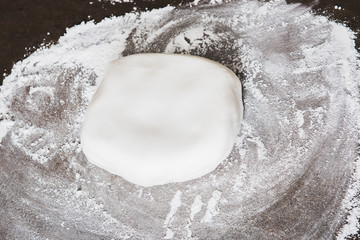 White fondant on dark stone kitchen counter
