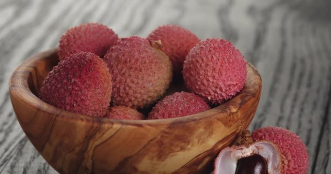 ripe lychees in wood bowl
