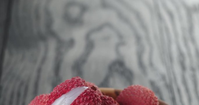 ripe lychees in wood bowl
