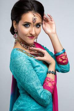 Portrait of beautiful smiling indian girl. Young indian woman model with traditional jewelry set . Indian costume saree