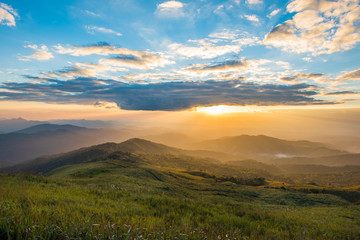 Dramatic sunset with beautiful vivid and romantic blue sky at Suan Ya Luang, Nan, Thailand. Beautiful panoramic mountain background.