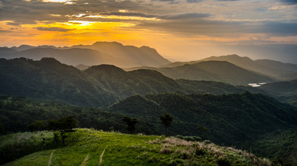 Dramatic sunise with beautiful vivid and romantic color sky at Khao Kho, Petchabun, Thailand. Warm light of dawn and panoramic scenery of mountain background.