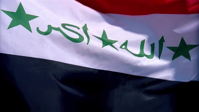 Saddam Era flag of Iraq rippling in the wind.