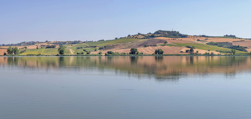 Fototapeta premium Beautiful panorama of Lake Chiusi, Siena, Italy, on a sunny summer day
