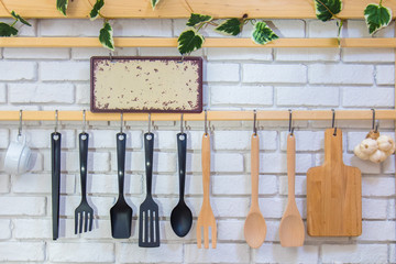  Kitchen utensils on the light brick background. Kitchenware and cooking ingrediants at home. Interior Decoration.