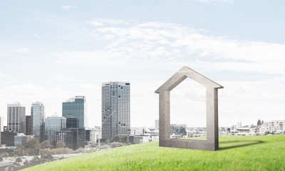 Obraz premium Conceptual image of concrete home sign on hill and natural landscape at background