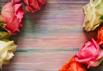 Colorful wooden background with red, pink and white roses