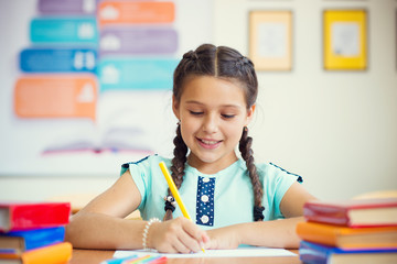 Cute smiling schoolgirl at school