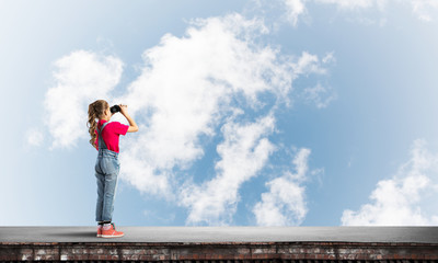 Concept of careless happy childhood with girl of school age looking in future
