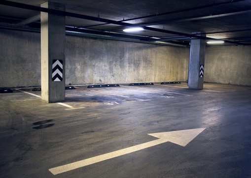 Empty dark abstract concrete room interior with white arrow. Architectural background