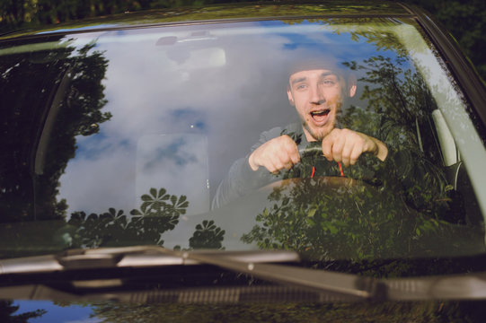 A Young Man Scared Screaming At The Wheel Of The Car Before The Accident. Road Traffic Accident, Collision On The Road