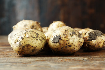 Young potato on a wooden background
