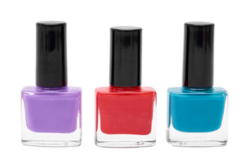 colored nail polish bottles isolated on white background