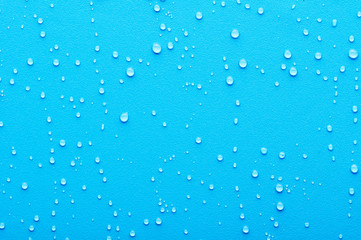 Naklejka na ściany i meble Water drops on a blue background