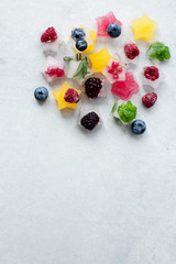 Ice cubes with berries and herbs in the form of a star