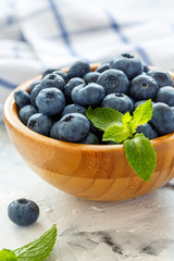 Ripe blueberries in a wooden bowl.