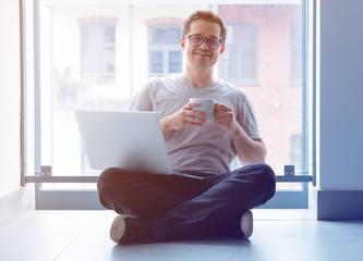 freelancer man using laptop computer and cup of coffee