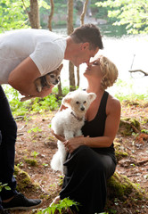 a couple touch noses and kiss with pets
