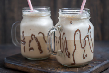 Cold coffee drink frappe frappuccino with whipped cream and chocolate syrup