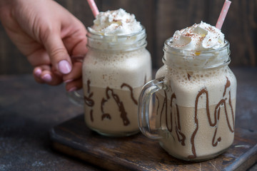 Cold coffee drink frappe frappuccino with whipped cream and chocolate syrup