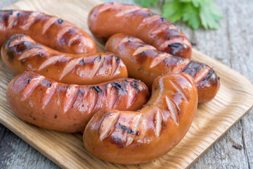 Grilled sausage on a old wooden board