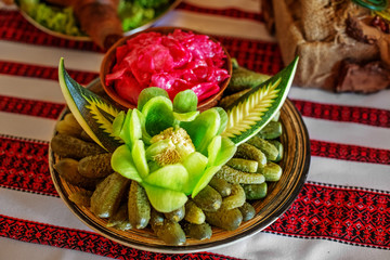 Pickled cucumbers with pepper on a plate. Red cabbage. The concept of food and Ukrainian cuisine.