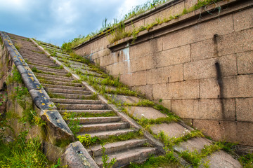 Fototapeta na wymiar Ancient stone stairs. Stairs in an abandoned building.