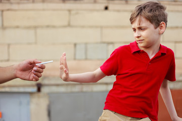 Schoolboy refuse the proposed cigarette. Bad habits, healthcare, stop smoking concept