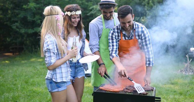 Friends spending time in nature and having barbecue