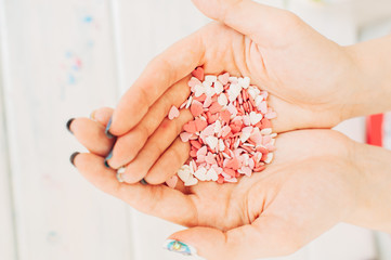 Sugar hearts in the hands of a girl