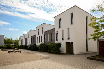 Modern townhouses in a residential area, new apartment buildings with green outdoor facilities in...