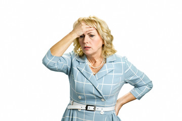 Worried mature woman touching head. Depressed white-skin businesswoman touching her face on white...