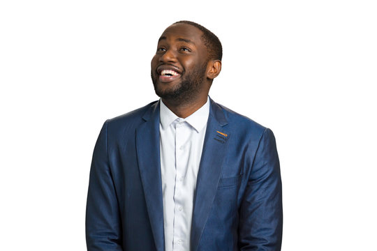 Looking upward and smiling manager. Successful afro american businessman smiling on white background. Natural human joy and happiness.
