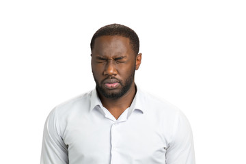 Dark skinned man with closed eyes. Afro american man in white shirt on white background closed eyes. Exhausted businessman want to sleep.