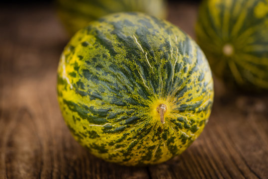 Wooden table with Futuro Melons (selective focus)