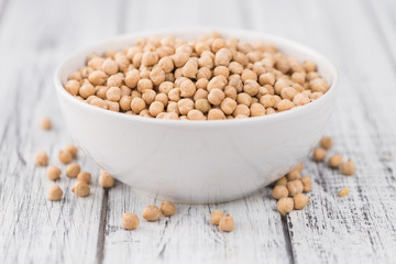 Portion of dried Chickpeas on wooden background, selective focus