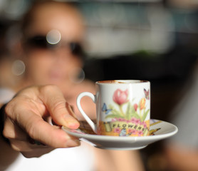 Frau zeigt Mokkatasse