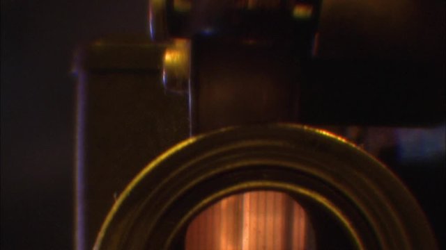 CU of working old motion picture projector.
