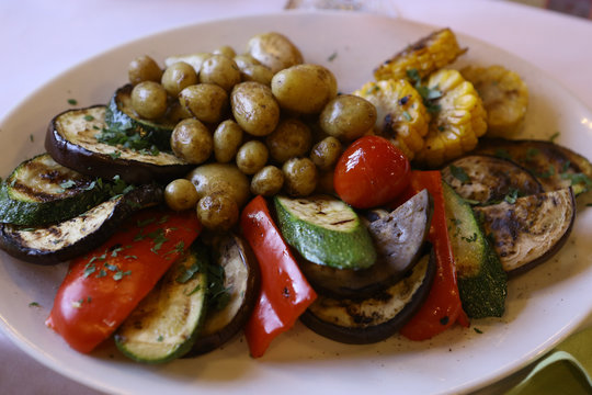 ratatouille on the plate with potato zukkini paprica pepper and corn 