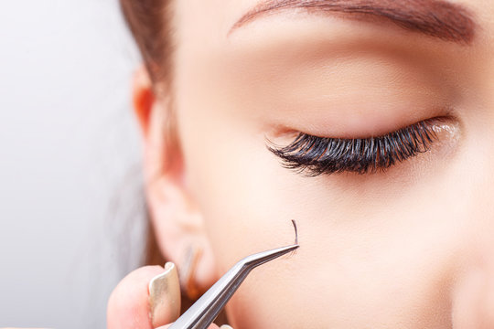 Eyelash Extension Procedure. Woman Eye with Long Eyelashes. Lashes, close up, macro, selective focus.