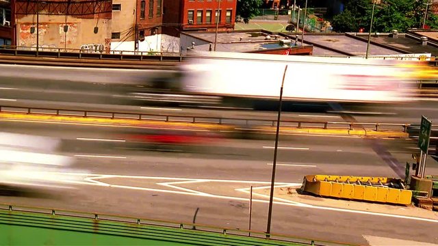Time-lapse daytime highway traffic.