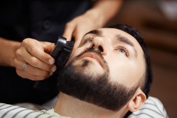 Man grooming client in chair