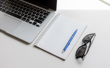 work desk with laptop and notebook