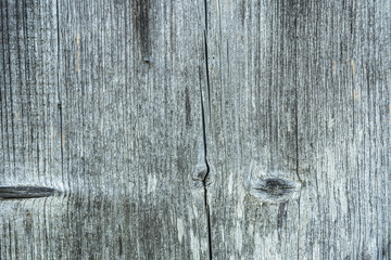 Dark texture of old natural wood with cracks from exposure to sun and wind