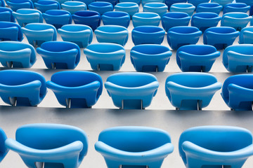 Rows of blue seats at football stadium. Convenient sitting for all