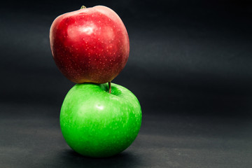 Two apples apple red and green isolated on dark background