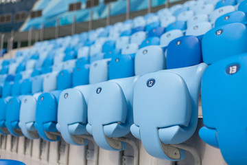 Rows of blue seats at football stadium. Convenient sitting for all